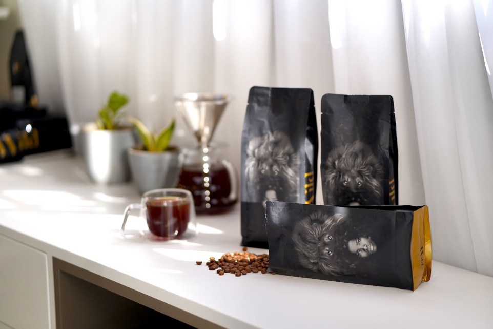 Thre coffee bag with roasted coffee beans on a desk