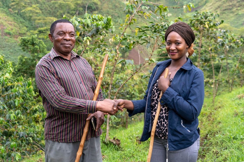 African coffee farmers with buyer shaking hands