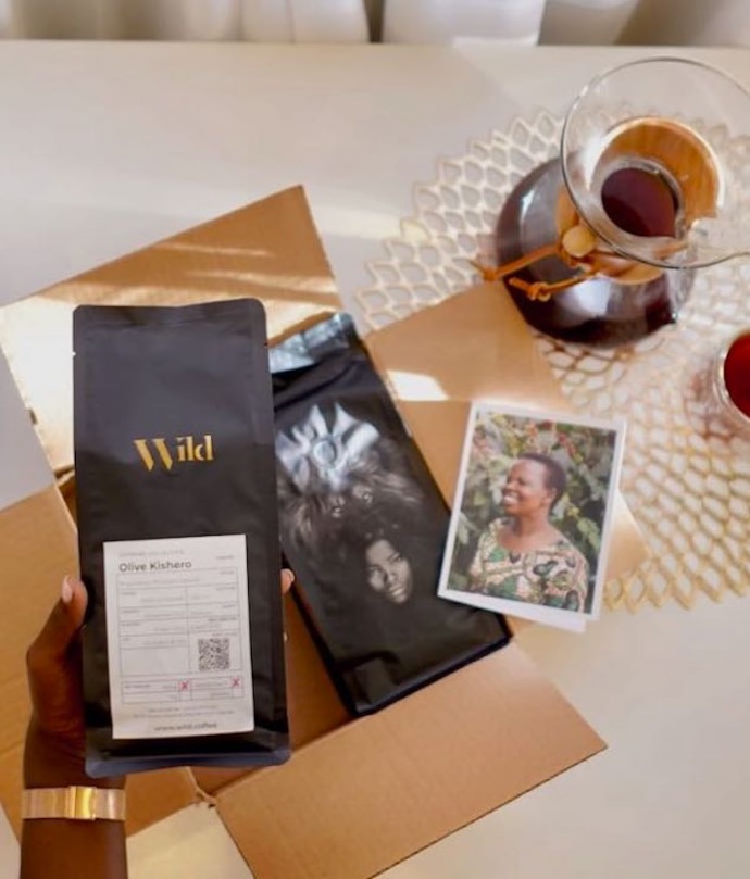Hand holding a bag of wild coffee when opening the coffee subscription box